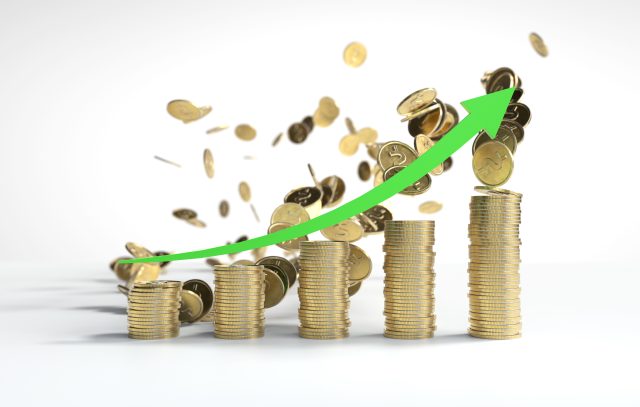 The green arrow is going up the Stacks of coins arranged in a ba